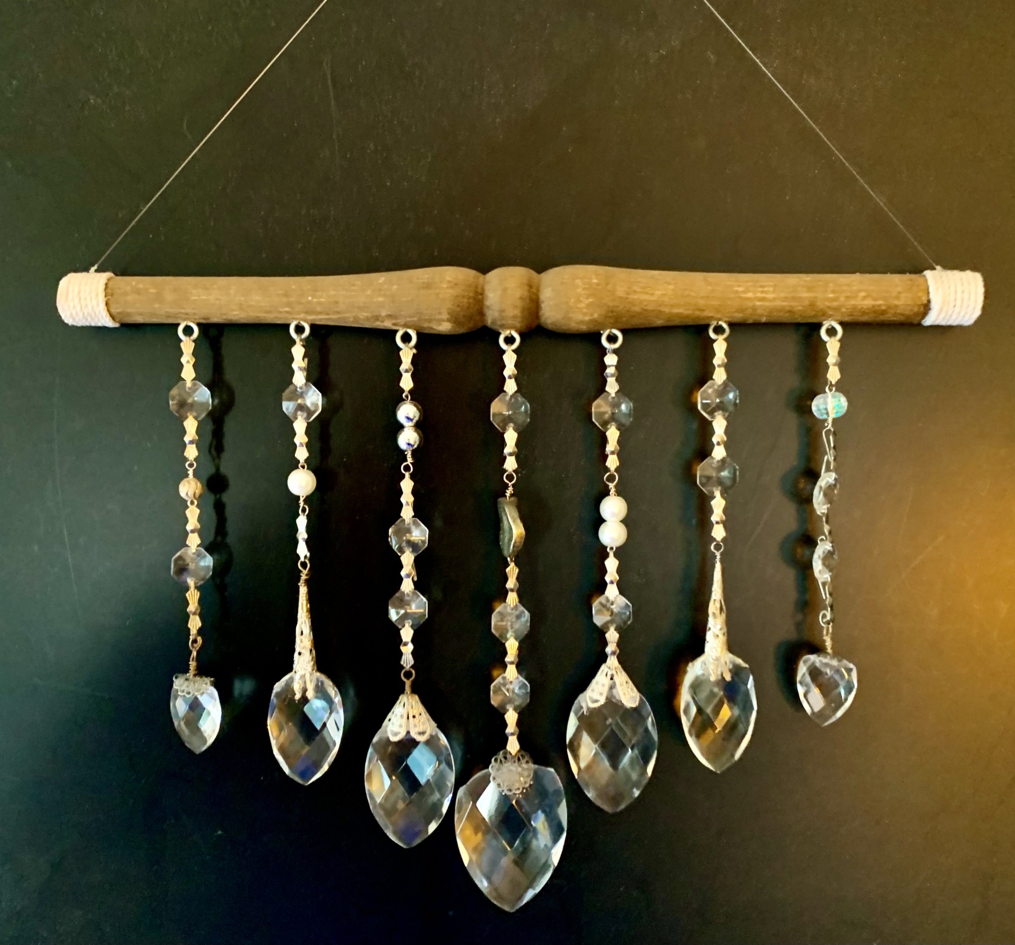 Assemblage piece with broken crystal, vintage chair dowel, cotton, mixed metals