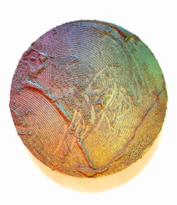 A rainbow circle of sand scraped through, on a white background. Lucas Stolz, Wabi Sabi, 2024