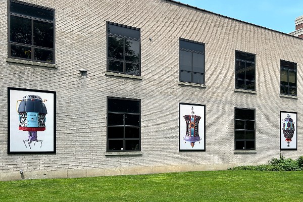 Photo of RoCo building with three large canvases for public art installation.