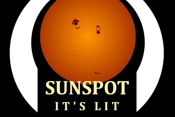 A warm perfect circle of the sun with dark spots on it surrounded by a white band and the words “Sunspot It’s Lit” on the bottom between the ends of the band, all on a field of black.